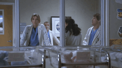 Doctors Standing in Hospital Room Looking Out Window