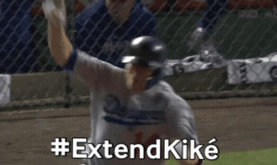 Dodgers Player Raising Arm While Teammate Looks On GIF