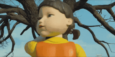 Doll In Front Of Tree With Blue Sky GIF