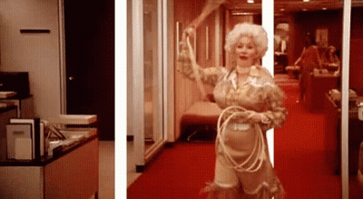 Doll In Pink Dress Sitting On Toilet Paper Bringing Style To The Bathroom GIF