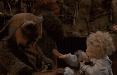 Doll Sitting At Table Talking To Stuffed Animal GIF