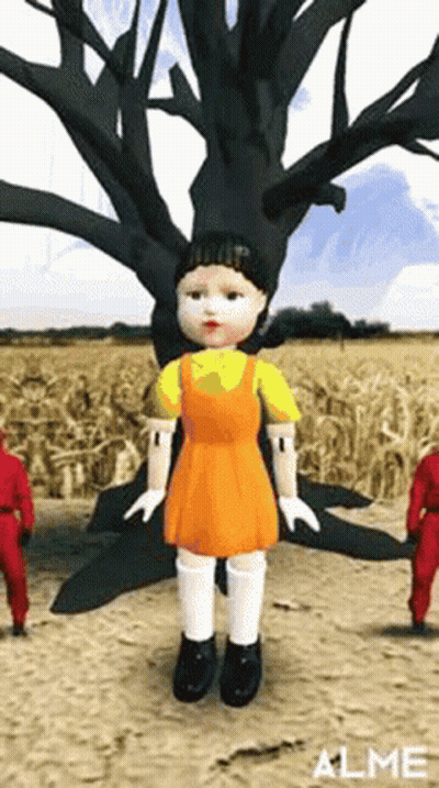 Doll Standing In Field Next To Tree GIF