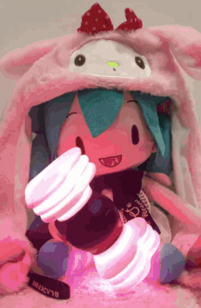 Doll Wearing Hello Kitty Hat Holding Light GIF