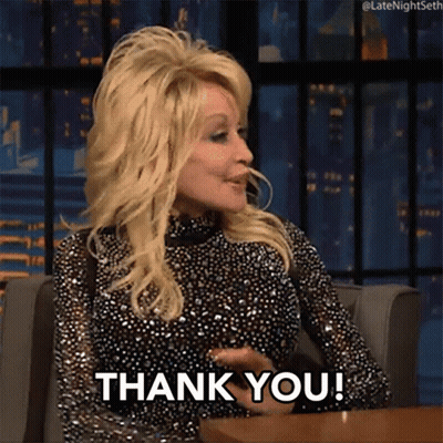 Dolly Parton Is Sitting At A Table And Saying " Thank You " GIF