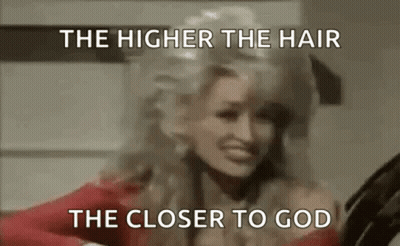 Dolly Parton Is Wearing A Red Dress And Has A Wig On . GIF
