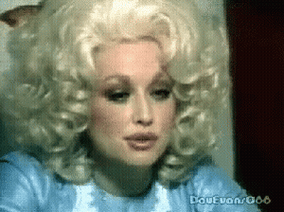 Dolly Parton Is Wearing A Wig And A Blue Dress GIF