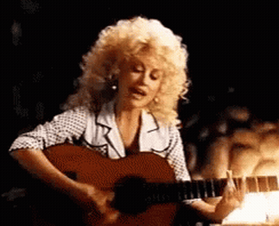 Dolly Parton Singing And Playing Guitar In Dark Room GIF