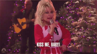 Dolly Parton Singing Into Microphone Saying Kiss Me Baby GIF