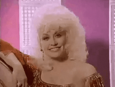 Dolly Parton Smiling In Gold Dress And Earrings GIF