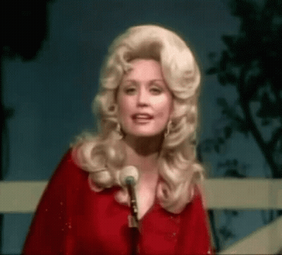 Dolly Parton Standing In Front Of A Microphone GIF