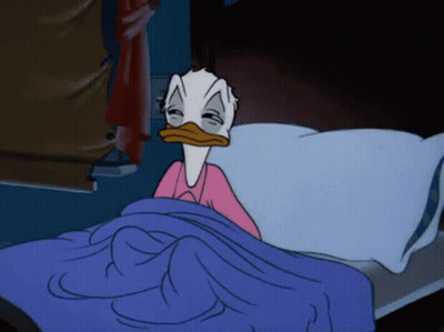 Donald Duck Is Laying In Bed With His Eyes Closed And A Pink Shirt On . GIF