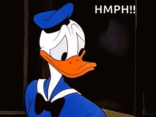 Donald Duck Is Making A Stop Sign With His Hand While Sitting At A Table . GIF