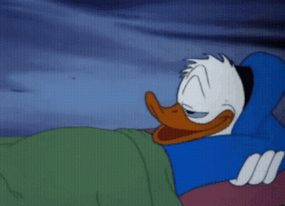 Donald Duck Is Sleeping On A Bed With His Eyes Closed . GIF