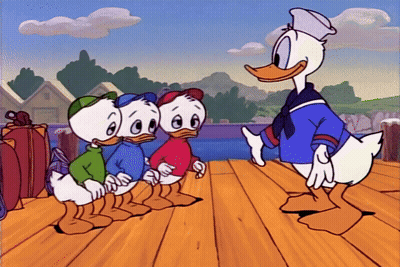 Donald Duck Standing Next to Three Ducks