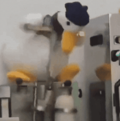 Donald Duck Stuffed Animal Sitting On Machine GIF