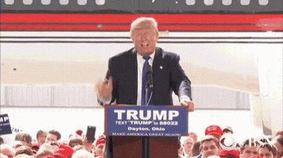 Donald Trump Is Giving A Speech At A Podium With A Sign That Says Trump GIF