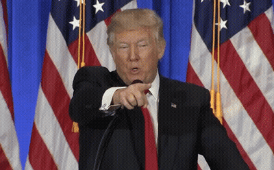 Donald Trump Is Pointing At The Camera While Standing In Front Of An American Flag GIF