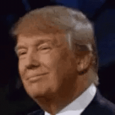 Donald Trump Is Smiling And Wearing A Suit And Tie In A Close Up Of His Face . GIF