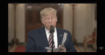 Donald Trump Is Speaking Into A Microphone While Reading A Piece Of Paper GIF