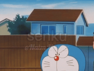 Doraemon In Front Of House With Fence GIF