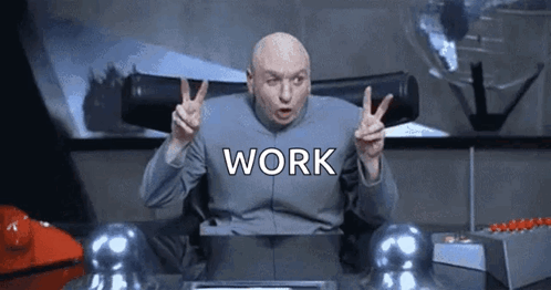 Dr. Evil Is Giving A Peace Sign While Sitting At A Desk With The Word Work Written On It . GIF