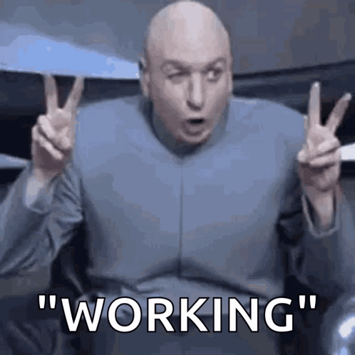 Dr. Evil Is Making A Peace Sign With His Hands And The Word Working Is Visible Behind Him . GIF