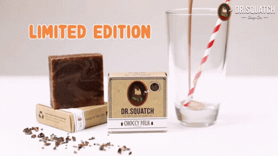 Dr Squatch Choccy Milk Soap Box Next To Glass GIF