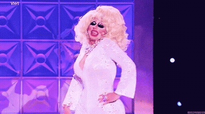 Drag Queen Dancing on Stage in White Dress