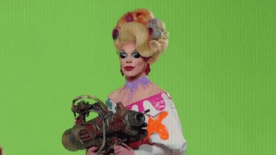 Drag Queen Holding Clapper Board Saying Rupaul GIF