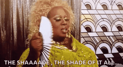 Drag Queen Holding Fan Saying The Shaaaade GIF