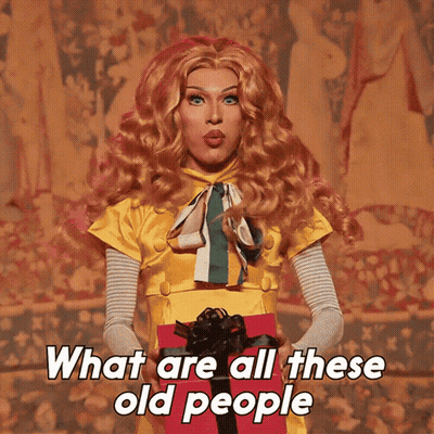 Drag Queen Holding Gift Box Saying What Are All These Old People GIF