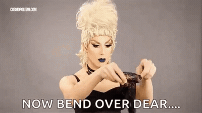 Drag Queen Holding Wig Saying Now Bend Over Dear GIF