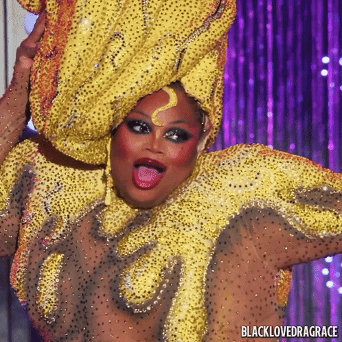 Drag Queen In Yellow And Gold Costume Saying Blacklovedragrace GIF