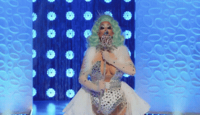 Drag Queen With Green Hair And White Dress On Stage GIF