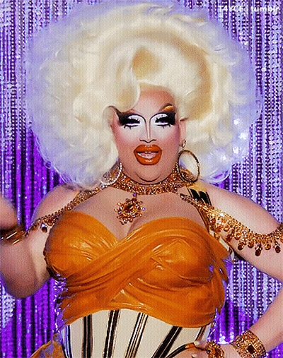 Drag Queen With Huge White Wig And Gold Corset GIF