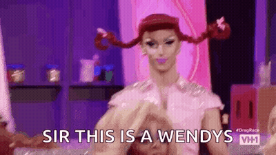 Drag Queen With Pigtails Making Heart Shape GIF