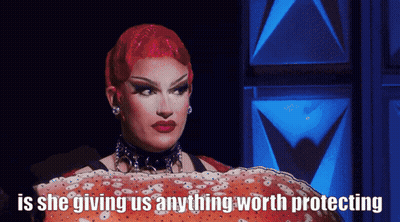 Drag Queen With Red Hair Holding Large Crab Saying Is She Giving Us Anything Worth Protecting GIF