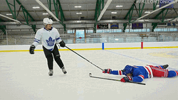 Dragging Another Player On Hockey Field GIF