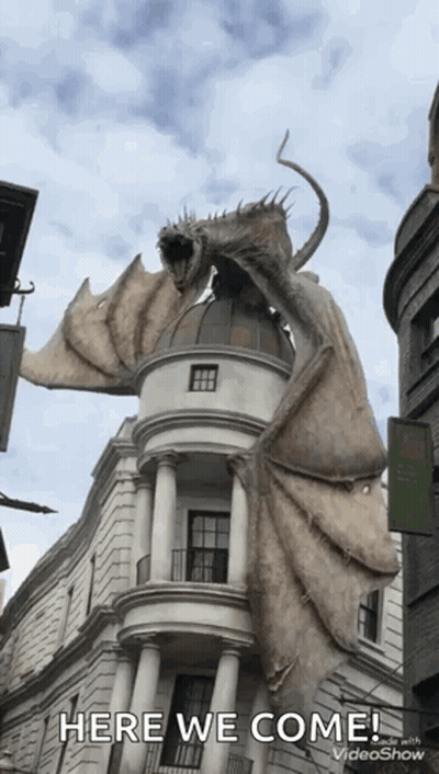 Dragon Statue Flying Over Building GIF