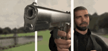 Drake Holding Gun Aiming Shooting