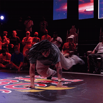 Dreadlocked Man Handstanding On Floor With Letter R GIF