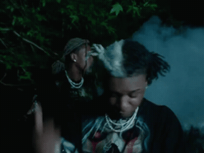 Dreadlocked Man In Black Skull Shirt And Necklace GIF