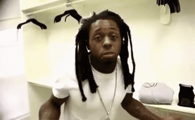 Dreadlocked Man In White Shirt In Closet GIF