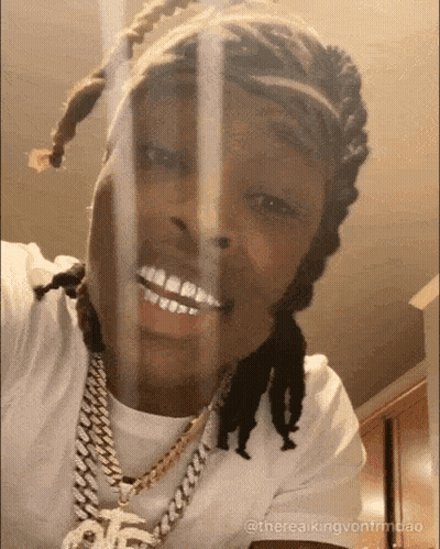 Dreadlocked Man In White Shirt Smiling At Camera GIF