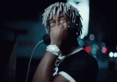 Dreadlocked Man Singing Into Microphone With Headphones GIF
