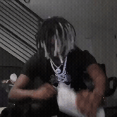 Dreadlocked Man Sitting On Couch Holding Money Bag GIF