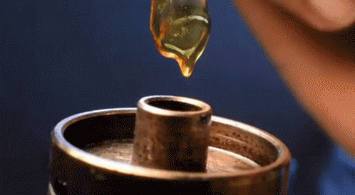 Drop Of Liquid Being Poured Into Metal Object GIF
