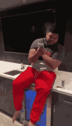 Druski Sitting And Holding Phone GIF