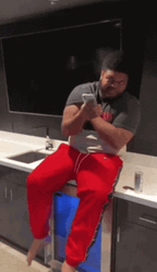 Druski We Got Em Holding Cellphone Sitting GIF