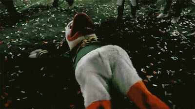 Duck Mascot Laying On Ground With Confetti GIF